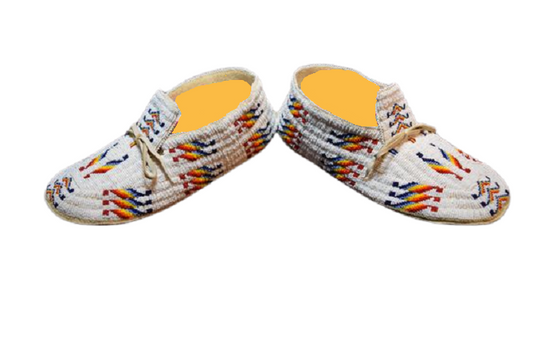 A pair of beaded moccasins with hand-stitched patterns and colorful beadwork, featuring a Sioux design.