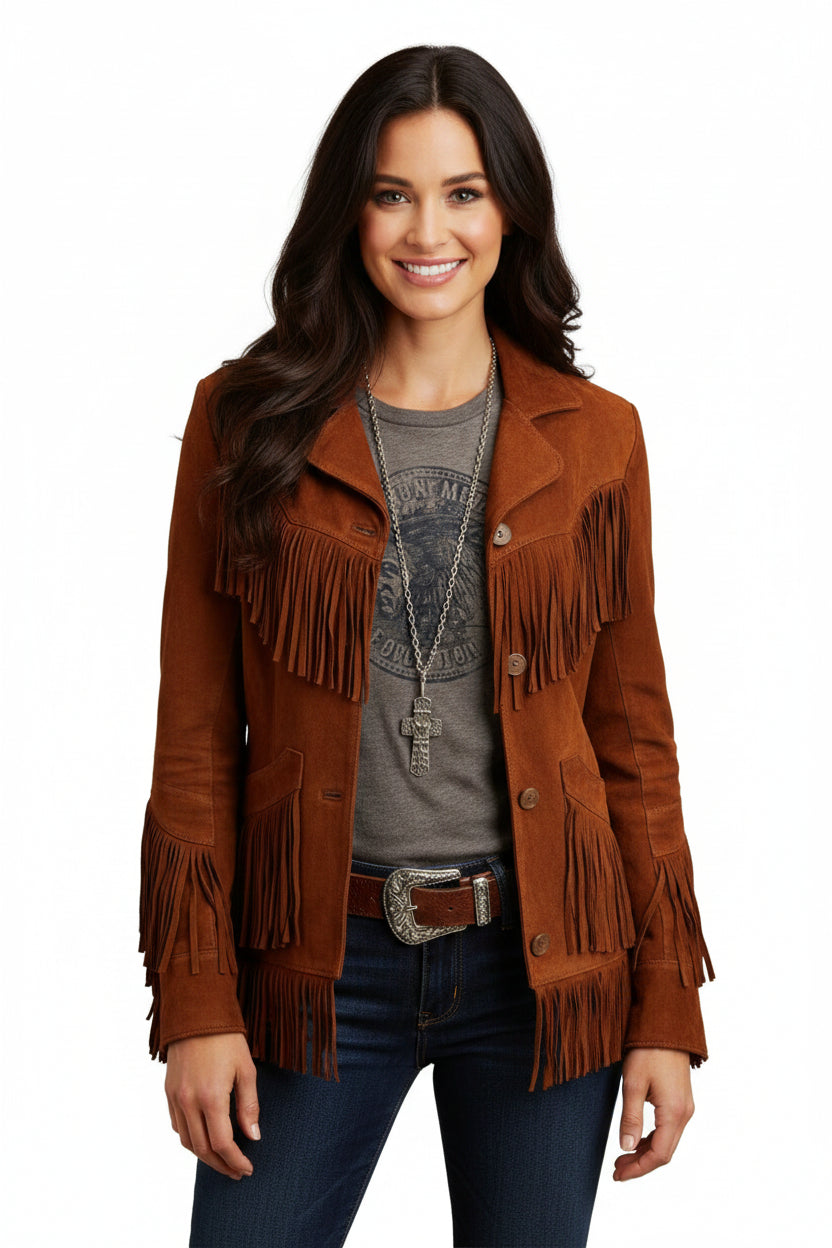 A woman wearing a brown suede leather fringe jacket with a button front closure, paired with blue jeans and accessorized with a necklace.