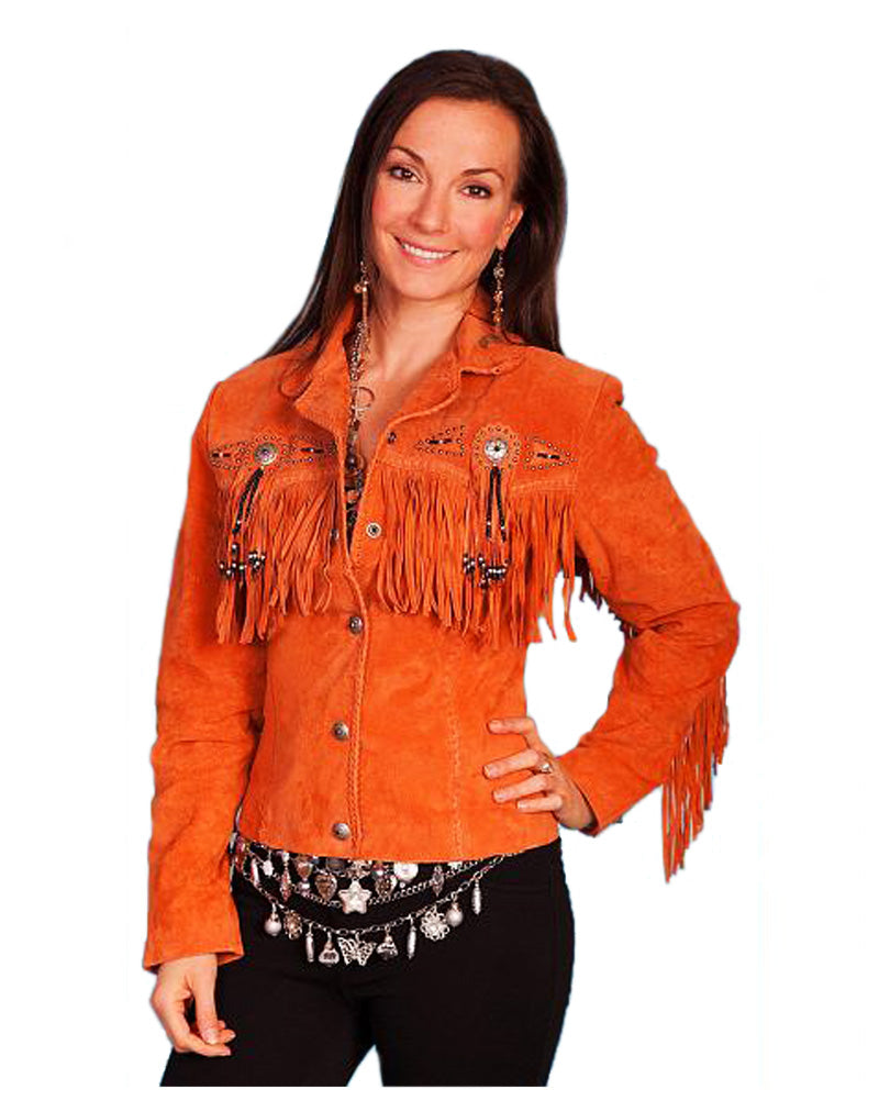 Woman wearing an orange suede jacket with fringe and embroidery on a white background