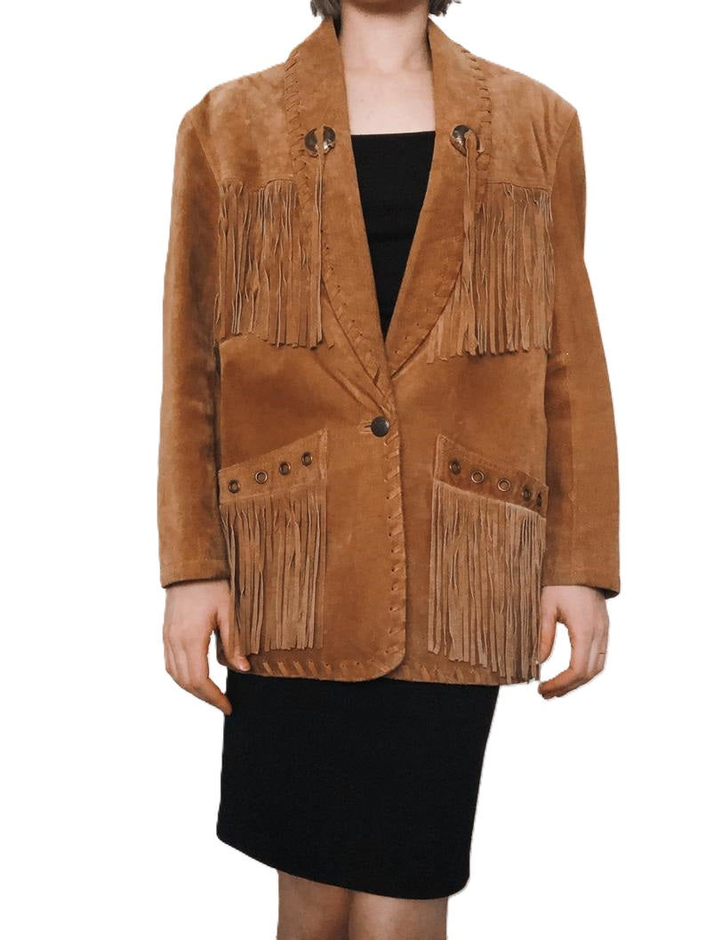 A woman wearing a brown suede leather fringe jacket with a mandarin collar and long fringe detailing, paired with a black dress.